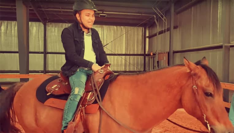 Kodi Lee rides a horse at Liberty University