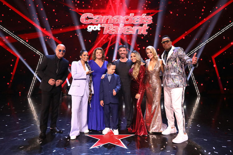 Howie Mandel, Lilly Singh, 2022 winner Jeanick Fournier, Simon Cowell, Trish Stratus, Lindsay Ell, and Kardinal Offishall celebrate during the "Canada's Got Talent" Live Finale at The Avalon Theatre